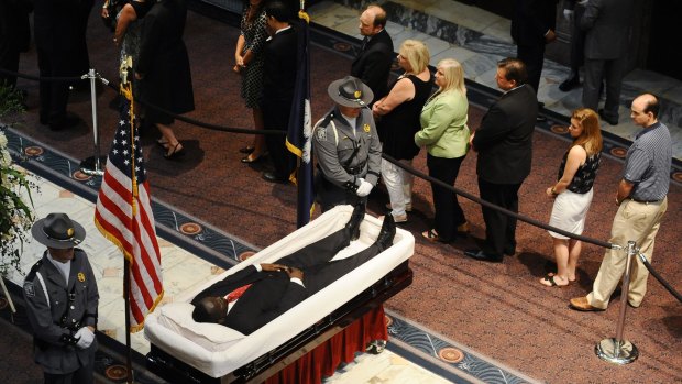 South Carolina Highway Patrol honour guards stand over Senator Clementa Pinckney's body as members of the public file past in the Statehouse on Wednesday in Columbia, South Carolina. 