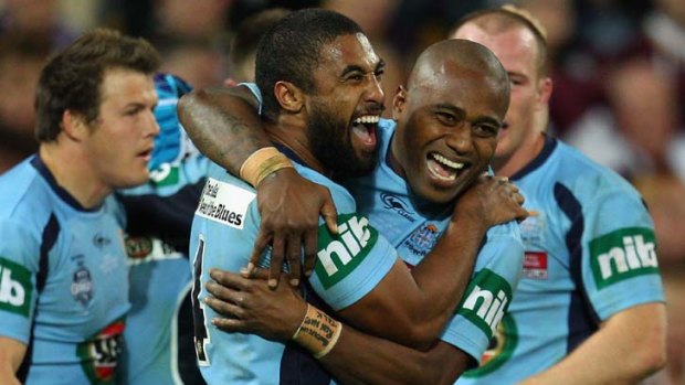 In demand ... Blues centre Michael Jennings, left, celebrates his try with Akuila Uate in Origin I.