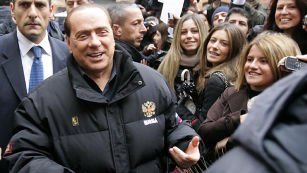 Silvio Berlusconi is greeted by supporters outside his home last month.