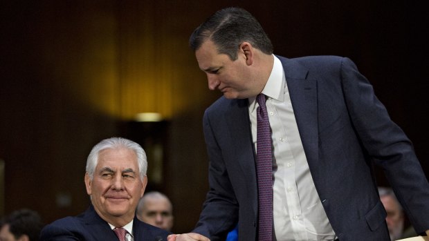 Senator Ted Cruz, a Republican from Texas, right, shakes hands with Rex Tillerson during his testimony.
