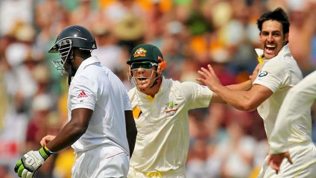 Mitchell Johnson celebrates after dismissing Michael Carberry.