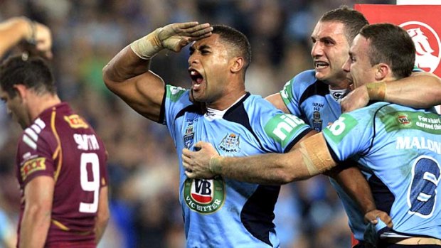 Blue salute: Michael Jennings celebrates with teammates after crashing over for a try.