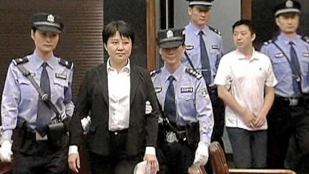 Chinese whispers … Gu Kailai and Zhang Xiaojun (at right) are escorted into court in August 2012.