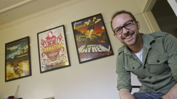 Designer Jeremy Saunders with his posters for The Motorcycle Diaries, Tarnation and Suburban Mayhem.
