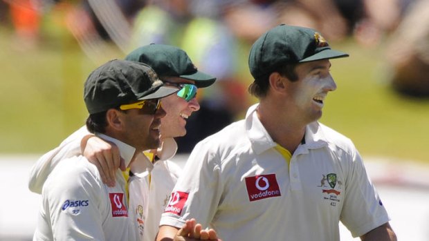 Ricky Ponting is congratulated by Michael Clarke and Shaun Marsh after catching a skied shot by Virender Sehwag.