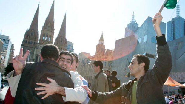 Libyan students from Melbourne celebrate the news that the Libyan government is on the brink of defeat.