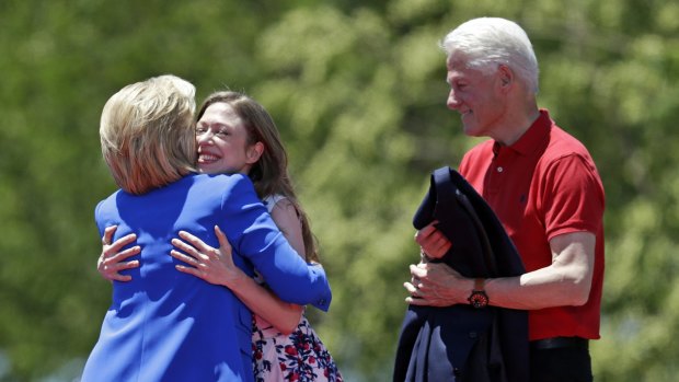 Chelsea Clinton hugs democratic presidential candidate, former Secretary of State Hillary Rodham Clinton, as former President Bill Clinton, right, watches them.
