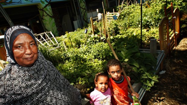 Sadeia Idris Aman with grandchildren Mariem and Mohammed at the Atherton Community Garden in the Collingwood Public Housing Estate.