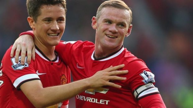 Wayne Rooney celebrates with teammate Ander Herrera after scoring his second goal this season against QPR.