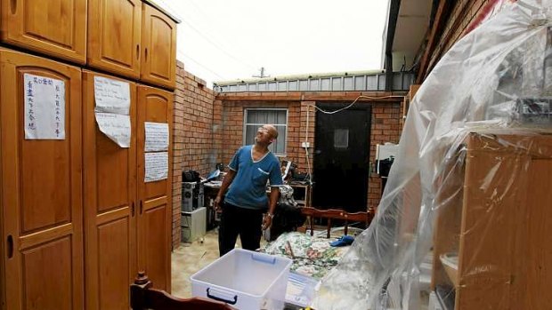 Chifley resident Harry Tran, pictured in one of the rooms in his house that lost its roof.