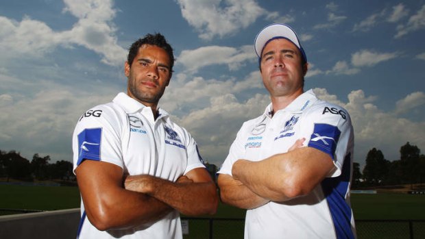 Sign on the dotted line: Coach Brad Scott and Daniel Wells standing firm with the Roos.