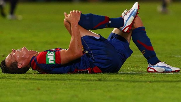 Grounded Jet &#8230; Ryan Griffiths feels the effects of a Perth Glory tackle on Friday.