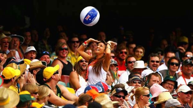 Members of the crowd have fun with a beach ball during yesterday's play at the Gabba.