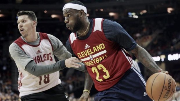 The King is back: Cleveland superstar LeBron James drives past Cavaliers forward Mike Miller.