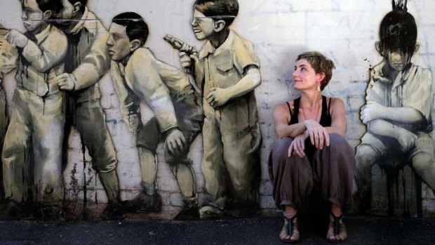 Anouk van Dijk in Fitzroy with a favourite piece of street art, by Taylor White.