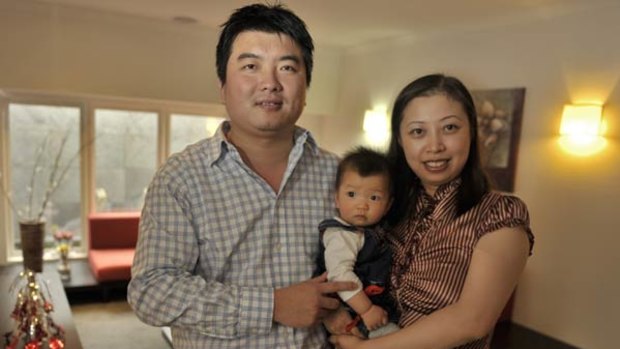 "Australia is paradise": Cranbourne local George Zhang, originally from China, with wife Rita Tian and daughter Ella.