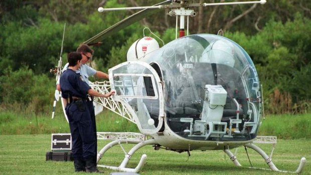 Police examine the helicopter used in the brazen jail escape by John Killick in 1999.