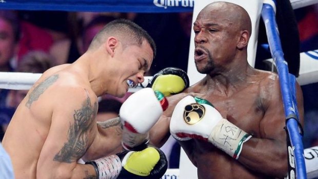Floyd Mayweather throws a right-hander to the face of Argentinean opponent Marcos Maidana at the MGM Grand Garden Arena in Las Vegas.