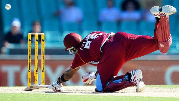 West Indies batsman Kieron Pollard dives to make his ground.