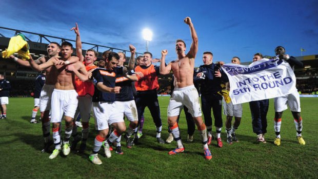 Party time: Luton Town players celebrate their unlikely victory.