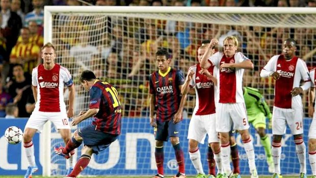 On target: Lionel Messi scores from a free kick for Barcelona.