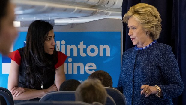 Hillary Clinton with senior aide Huma Abedin aboard her campaign plane.