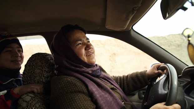Sara Bahayi has had her taxi license for two years. The $10 to $20 she earns each day is enough to provide for her 15 relatives, including her ailing mother.