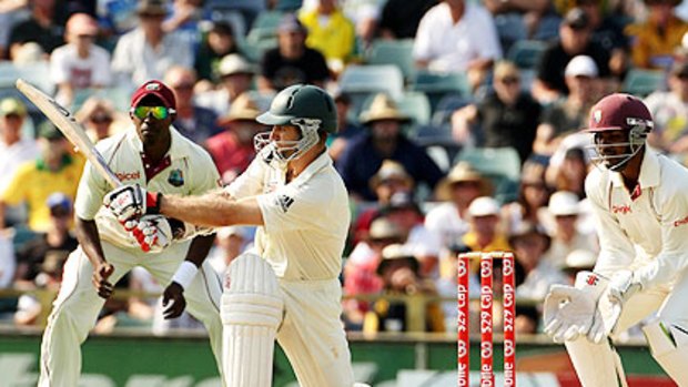 Opener Simon Katich sweeps and is caught by Kemar Roach at square leg for 99 in Perth yesterday.