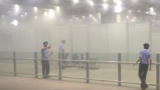 A mobile phone photo of police officers work at terminal 3 after the homemade bomb exploded at Beijing's international airport.