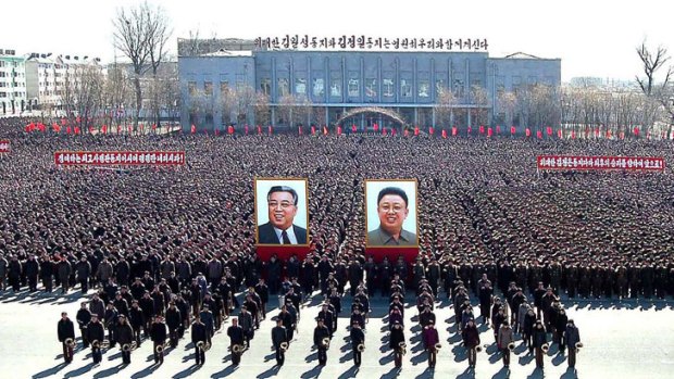North Korean citizens and soldiers attend a rally held to support in North Pyongang Province on March 10, 2013.