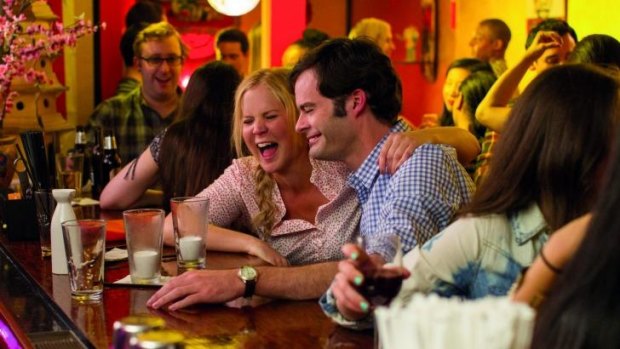 Amy Schumer as a lustful barfly and Bill Hader as a surgeon and potential love interest, in <i>Trainwreck</i>.