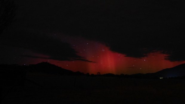 The pink-red glow of the Aurora Australis above Mt Tennent on Tuesday morning.