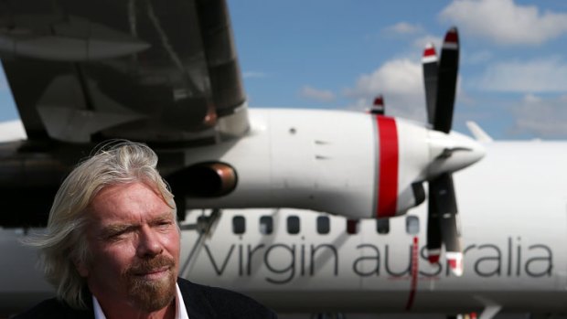 Sir Richard Branson with a Virgin turboprop aircraft used on regional routes