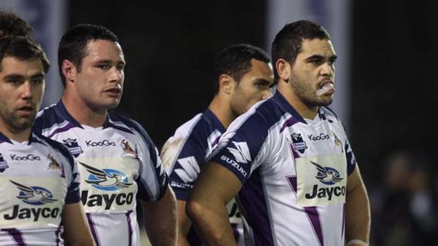 Cameron Smith (L) Brett White and Greg Inglis of the Storm reflect after the Warriors scored a try last night.