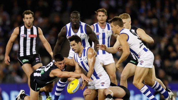 Scott Pendlebury of the Pies and Daniel Wells of the Roos compete for the ball.