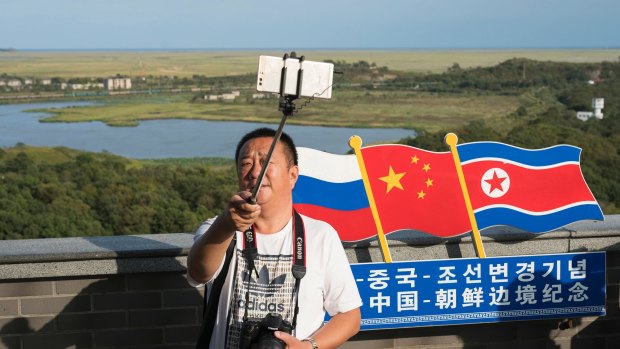 A man takes selfie at the border which separates China, North Korea and Russia, in Yanbian in China's Jilin province.