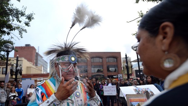 Robert Ironshield Jr is blessed by Kumai Yaqui Chicana during a protest in Boulder.