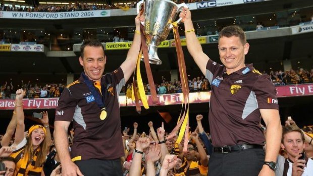 Bolton, right, celebrating the Hawks premiership with Alastair Clarkson.