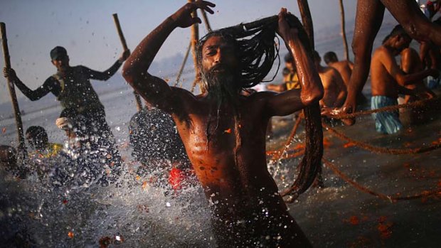 Bathing on a grand scale ... a Hindu holy man joins up to 20 million other pilgrims on Sunday in ritual washing in the Ganges River in Allahabad.