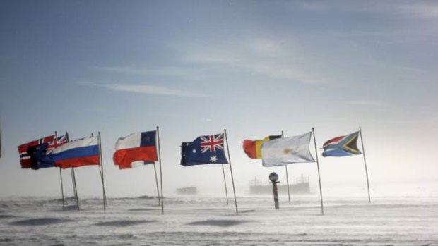 Flags of the signatories to the Antarctica Treaty flutter at the South Pole, first visited a century ago.
