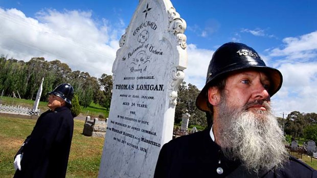 In memorial: Two members of the Victoria Police Historical Society stand at the restored grave of Constable Thomas Lonigan.