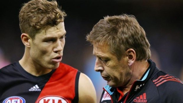 Essendon's Jake Melksham has a word with his coach Mark Thompson during a break.