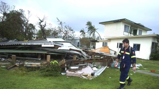 Safety first ... a fire and rescueworker in Tully Heads monitors structural damage.