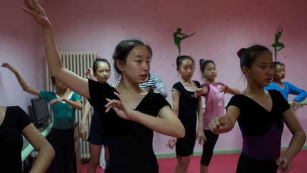 Ma Qianyi, 12, left foreground, during a three-hour dance lesson she attends after a full school day in Beijing.