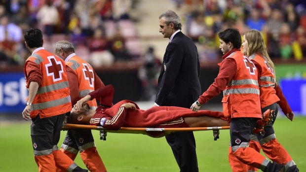 Trouble: Spain's Alvaro Morata laments as he leaves the pitch on a stretcher, during their Euro 2016 qualifier match against Luxembourg. 
