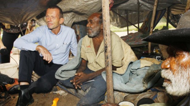 Question time ...  Tony Abbott meets Michael Gorey and David Wingarmara under a tarpaulin on the outskirts of Hoppy’s Camp.