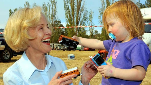Woman of the people: Quentin Bryce with a child during the Victorian bushfires in 2009.