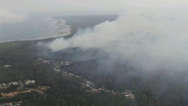 The fire burning on North Stradbroke Island near the township of Dunwich on Monday morning. Photo: Penny Dahl, Australian Traffic Network, via Twitter.