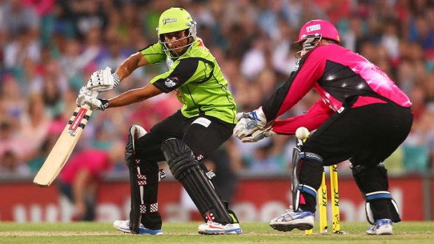 Sleight of bat: Usman Khawaja opens the face of the bat against the Sixers during the opening round of the Big Bash at the SCG on December 21.