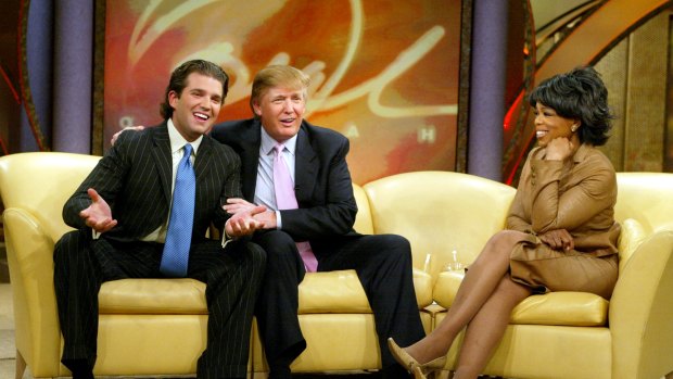 Donald Trump (centre), with Donald Trump Jnr and Oprah Winfrey in 2004: intuitively understood - and successfully exploited - the weaknesses in American journalism. 
